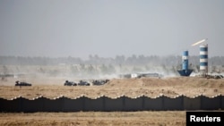 Iraqi security forces vehicles are seen in Fallujah on June 17.