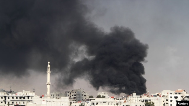 Smoke rises from the eastern Damascus suburbs of Arbeen after what activists say was an air strike by a fighter jet on November 8.