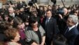 Armenian President Serzh Sarkisian (far right) talks to residents of the village of Akhuryan during a working visit on April 7, a month before national elections.