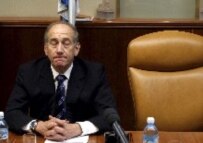 Acting Prime Minister Ehud Olmert sits next to Sharon's empty chair during an emergency cabinet meeting yesterday (epa)