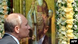Russian President Vladimir Putin kisses an icon during a service and ceremony in Kyiv on July 27 to celebrate the 1,025th anniversary of Christianity in Ukraine and Russia.