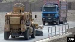 A U.S. mine-resistant ambush-protected (MRAP) vehicle patrols a highway leading to the border with Pakistan used for transporting goods in Afghanistan's Khost Province.