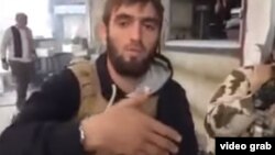 A screen grab from the video purporting to show Azerbaijani Fariz Dostaliyev enjoying a meal while fighting with Islamic State (IS) in Syria.