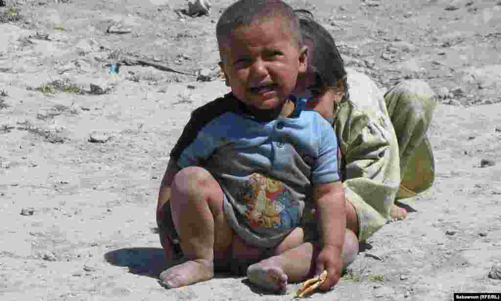 Children play by the roadside.