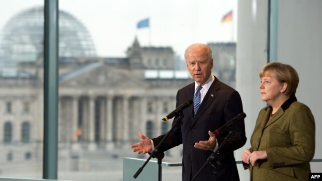 German Chancellor Angela Merkel and U.S. Vice President Joe Biden talk to journalists at the chancellery in Berlin.