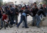 Demonstrators attacking the TIPH headquarters in Hebron on 8 February (epa)