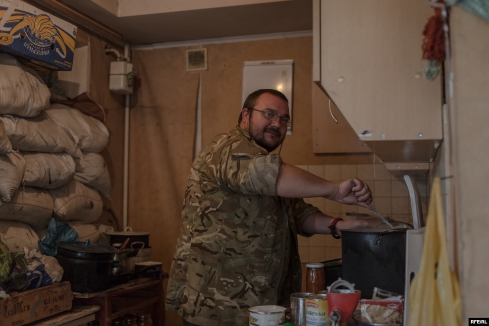 "Tuna" makes dinner. He once ran his own business, but joined the unit a few months ago and pays monthly salaries to some of the fighters out of his own pocket.