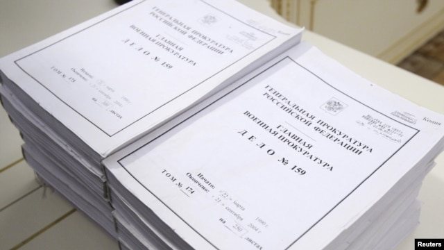 Volumes of declassified information lay on a table during the ceremony in Moscow on April 7.