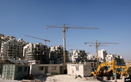 Construction cranes and excavators at the building sites of new housing units in the Jewish settlement of Har Homa in East Jerusalem