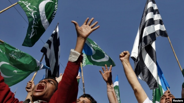 Supporters of Islamic parties hold party flags and shout slogans as they demand punishment for Aasia Bibi, the Christian woman sentenced to death for blasphemy, at a rally in Karachi last month.