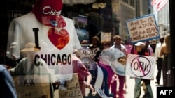 Demonstrators are reflected in a souvenir shop window in Chicago, Illinois, as peace activists march through the street demanding an end to NATO violence ahead of the summit.