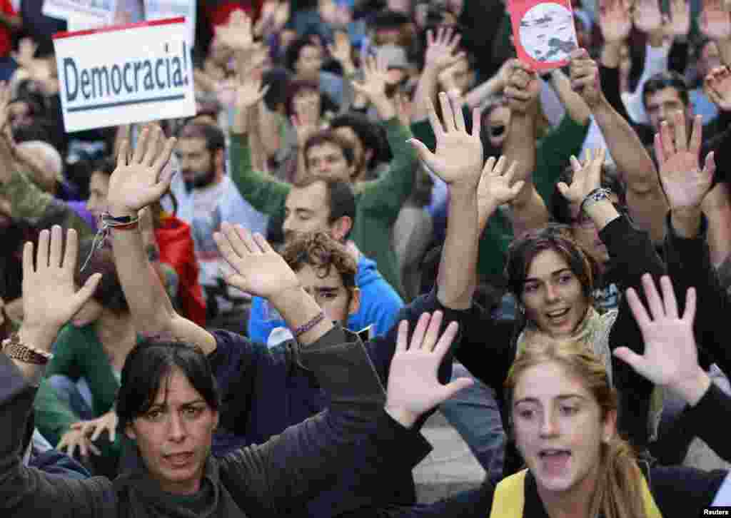 Spanish antiausterity protesters shout slogans during a demonstration outside Madrid's Parliament on September 26. (REUTERS/Susana Vera)