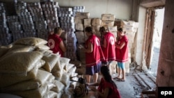 International Committee of the Red Cross workers enter a storehouse to check products after a Ukrainian convoy delivered humanitarian aid for eastern Ukrainian regions, in the town of Starobilsk, in August 2014.