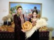 Turkmenistan – Turkmen women dressed in traditional dresses standing in front of typically decorated Noruz table with special Noruz bread, Ashgabat, 2007