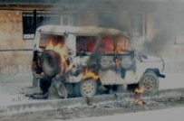 A police vehicle burns following the violence (RFE/RL)