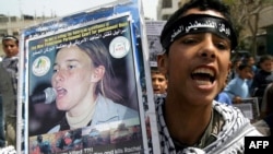 A Palestinian supporter holds up a placard showing Rachel Corrie during a demonstration in the southern Gaza Strip. (file photo)