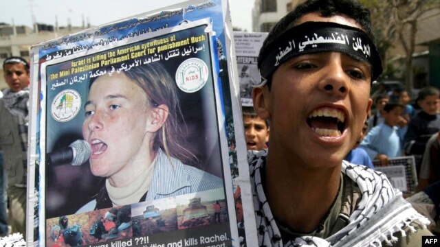 A Palestinian supporter holds up a placard showing Rachel Corrie during a demonstration in the southern Gaza Strip. (file photo)
