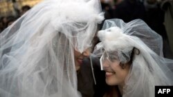 Two women in wedding veils in front of Notre-Dame Cathedral in Paris during a demonstration in December for the legalization of gay marriage and LGBT (lesbian, gay, bisexual, and transgender) parenting.