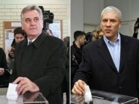 Tomislav Nikolic (left) and Boris Tadic, in a screen split, voting today in Belgrade (AFP)