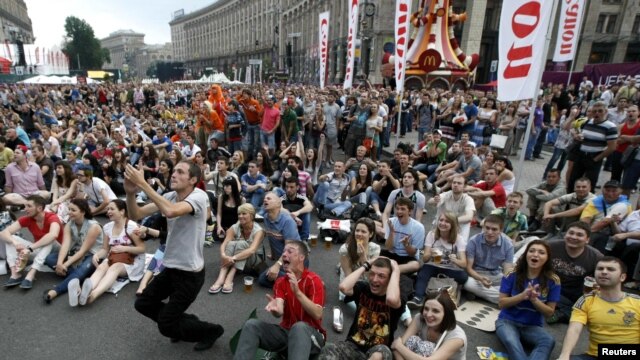 Soccer fans react as they watch the soccer match between the Netherlands and Denmark in the fan zone in Kyiv 