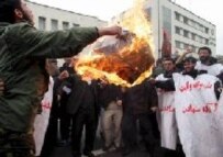 Protesters burn the Israeli flag in front of the German Embassy in Tehran on 14 February (epa) 
