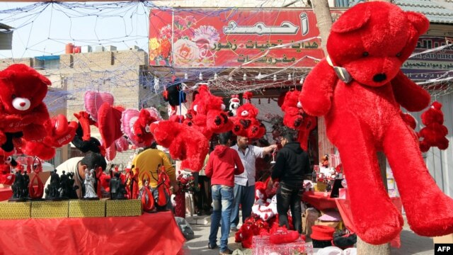 Huge red bears and other soft toys are prominently displayed for sale by a vendor on Valentine's Day in Baghdad.