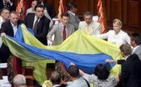 Yuliya Tymoshenko and other deputies from her faction unfurl a national flag in the legislative chamber today (epa)