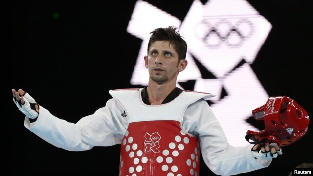 Iran's Mohammad Bagheri Motamed celebrates winning the silver medal in the under-68-kilogram  taekwondo competition at the London Olympic Games.