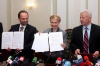 From left to right: Roman Bezsmertny, campaign chief of the pro-presidential Our Ukraine party, former Prime Minister Yuliya Tymoshenko, and Socialist party leader Oleksander Moroz display a protocol agreement they signed today for a new governing coalition (epa)