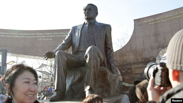 People attend a ceremony to unveil a monument that includes a sculpture of President Nursultan Nazarbaev in Almaty on November 11.