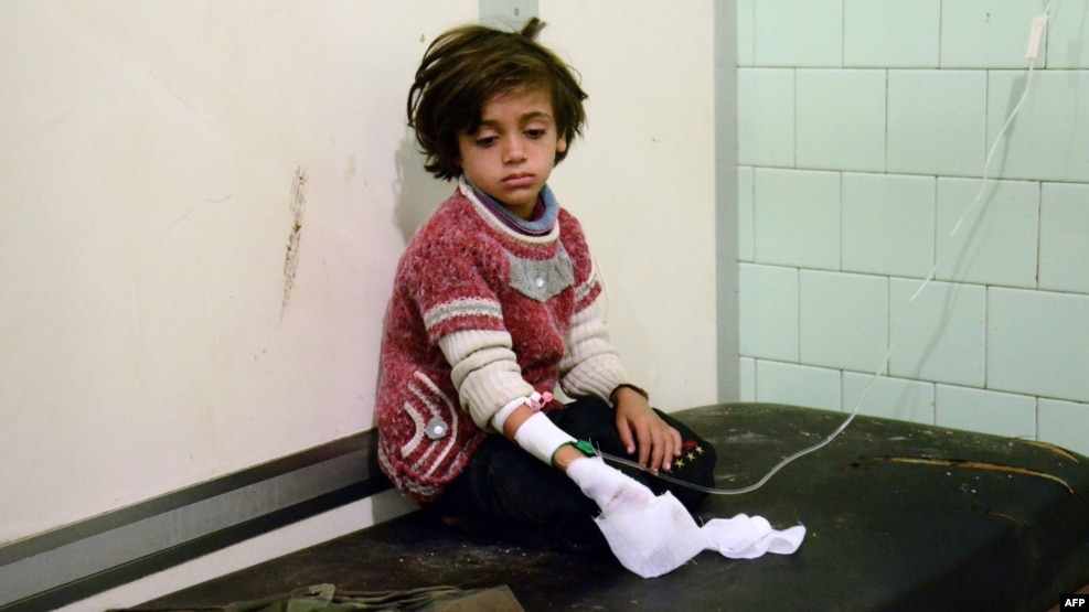 An injured child waits after receiving treatment at a hospital in a government-held neighborhood in the northern city of Aleppo on November 3.