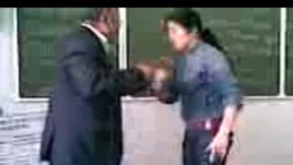A student purported to be the daughter of an Uzbek prosecutor beats and humiliates a teacher at a university in Uzbekistan.