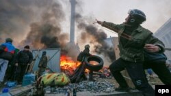 An antigovernment protester uses a catapult during clashes with riot police in downtown Kyiv on February 19. As the protests became increasingly heated, some of the language used in connection with them has been equally incendiary.