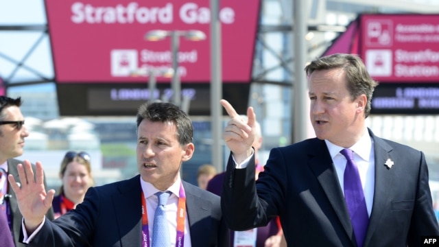 British Prime Minister David Cameron (right) speaks to London Olympics organizer Sebastian Coe during a visit to the Olympic Park in London on July 26.