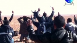 A still image broadcast on Algerian TV shows hostages surrendering to Islamist gunmen at the gas facility.