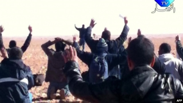 A still image broadcast on Algerian TV shows hostages surrendering to Islamist gunmen at the gas facility.