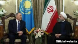 Kazakh President Nursultan Nazarbaev (left) with his Iranian counterpart Hassan Rohani in Tehran on April 11.