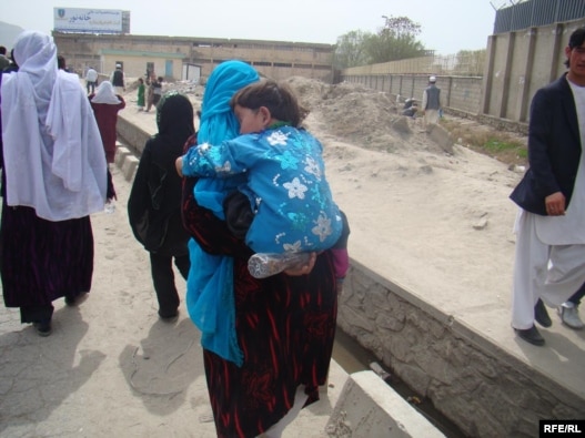 Norouz celebrations included trips to holy shrines, like that of this Afghan woman and her son in Kabul.