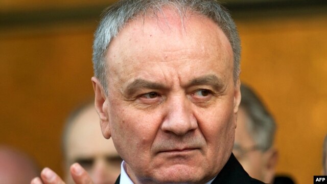Moldovan President-elect Nicolae Timofti applauds in the parliament in Chisinau shortly after the presidential vote in which he was elected on March 16.