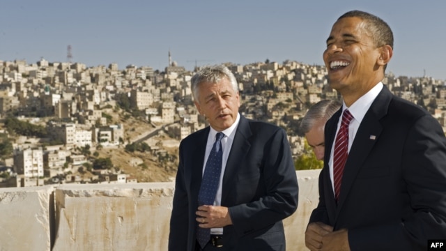 U.S. President Barack Obama (right) shares a laugh with U.S. Senator Chuck Hagel as they tour the citadel of the Jordanian capital Amman. (file photo)