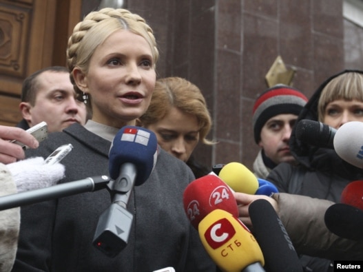 Former Ukrainian Prime Minister Yulia Tymoshenko talks to the media as she arrives at the state prosecutor's office in Kyiv on December 15