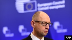 Ukrainian Prime Minister Arseniy Yatsenyuk talks to the press after attending meetings at the European Council in Brussels on March 19.