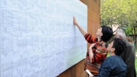 Armenia - Voters look for their names on electoral rolls posted outside a polling station in Yerevan, 6May2012.