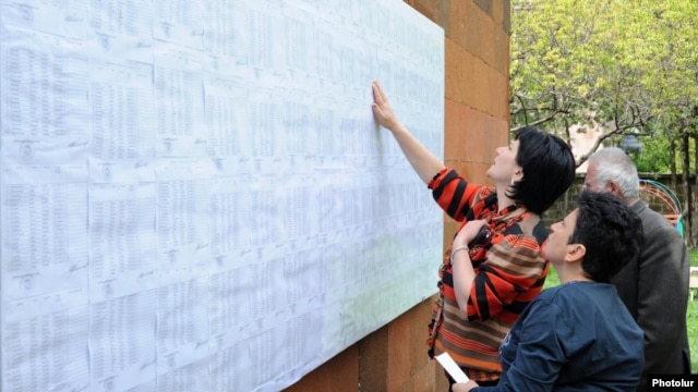 Armenia - Voters look for their names on electoral rolls posted outside a polling station in Yerevan, 6May2012.