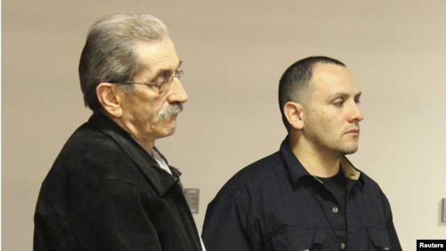 Dejan Radojkovic (left), a former Bosnian-Serb police commander wanted in his native country for alleged atrocities at Srebrenica, is seen in Las Vegas during his deportation on May 23.