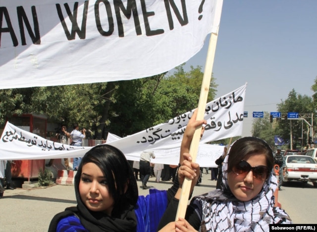 Afghan women march in Kabul on July 11 to protest the public execution of a young woman for alleged adultery.