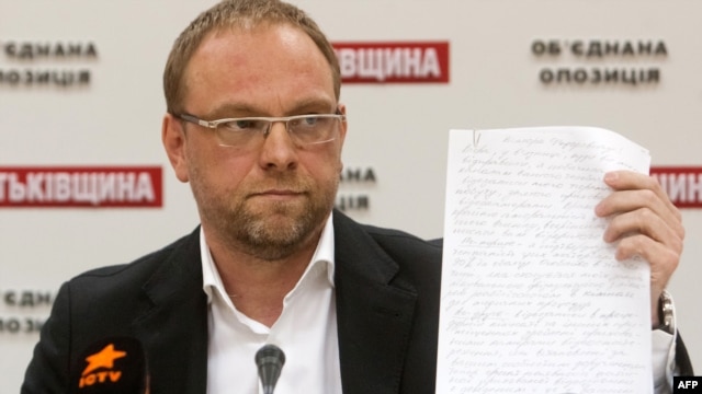 Serhiy Vlasenko, a lawyer for Yulia Tymoshenko, displays a letter she wrote to the President Viktor Yanukovych during a press conference in Kyiv in October.