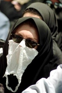 A student covers her face during a demonstration in Tehran on July 11, 1999 (AFP)