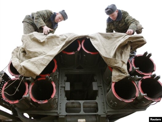 Uncovered? Soldiers cover multiple missile launcher 'Smerch' as they take part in a military exercise near the Belarusian town of Osipovichi. (file photo)