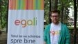 Gay activist Artiom Zavadovsky stands by a poster for Egali.md, a web platform and a video campaign in support of LGBT and gay Moldovans.